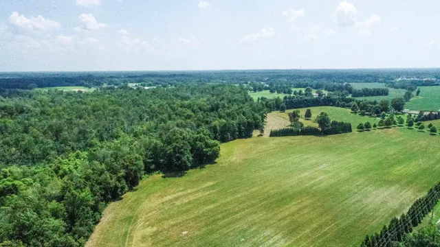 an aerial view of a house with yard