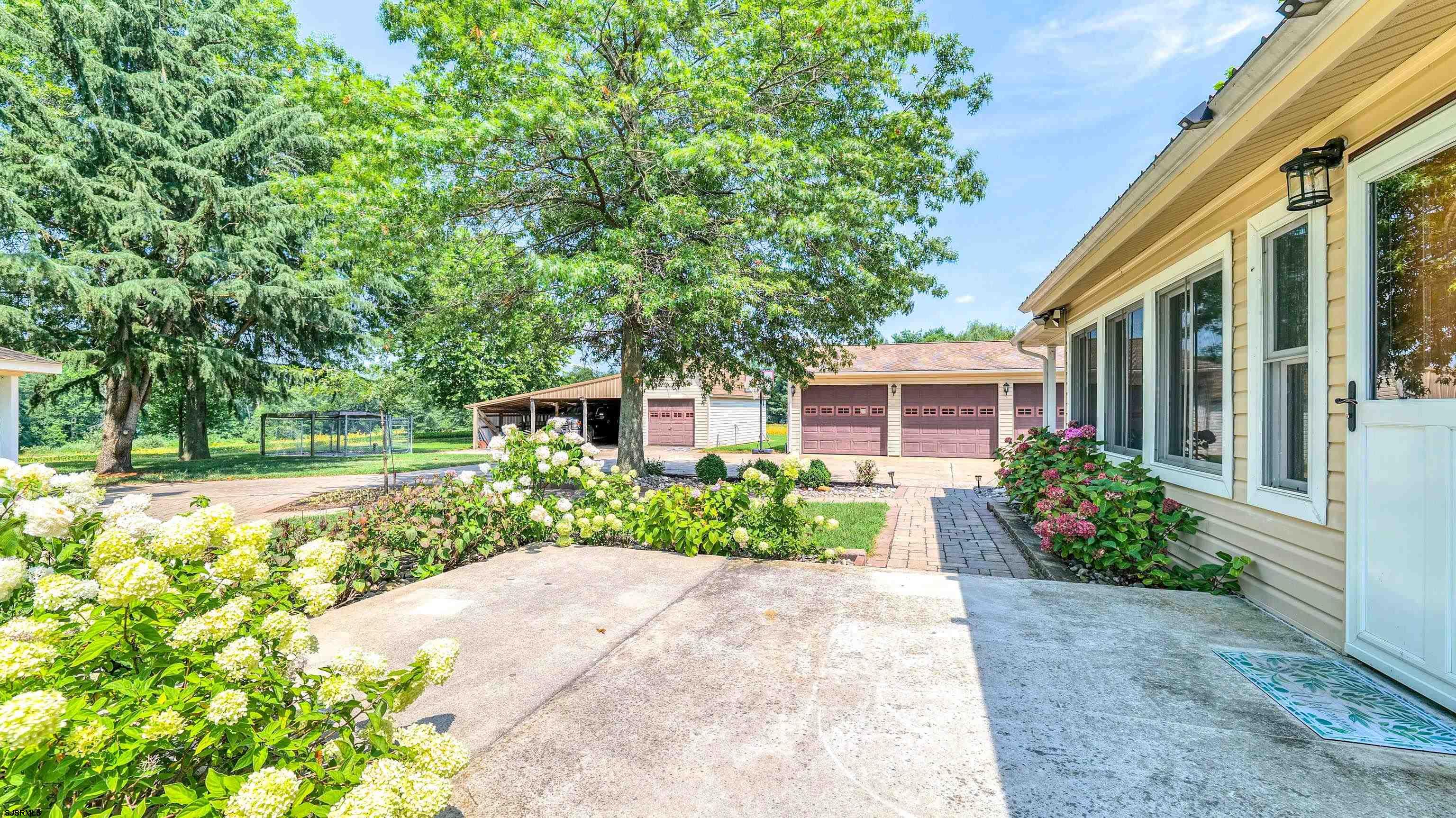36 Cream Ridge Road Salem, NJ 08079 - Photo 41 of 53 a front view of a house with a yard and a garden