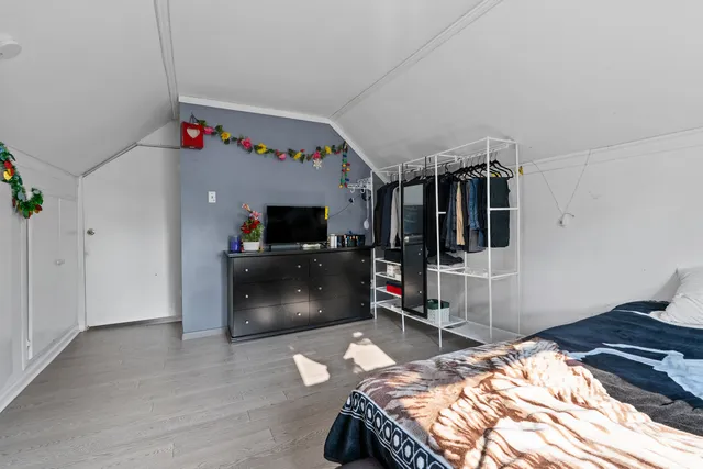 a bedroom with a bed and a flat tv screen