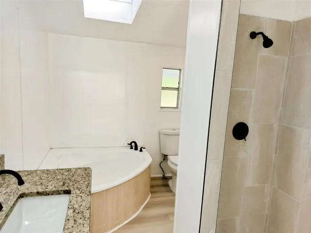 a view of a hallway with a window and a ceiling fan