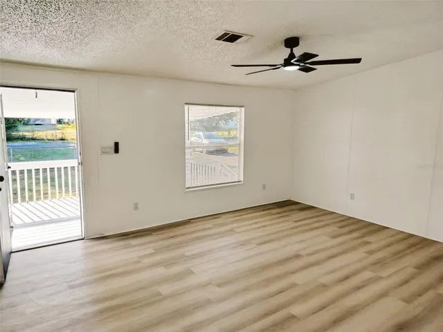 a kitchen with stainless steel appliances granite countertop a refrigerator a stove and a sink