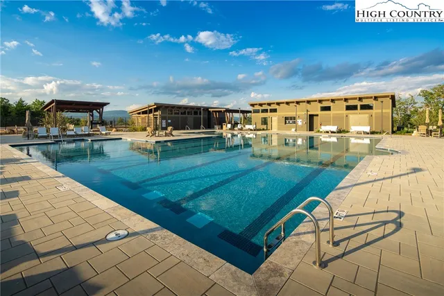 a view of a swimming pool with a yard