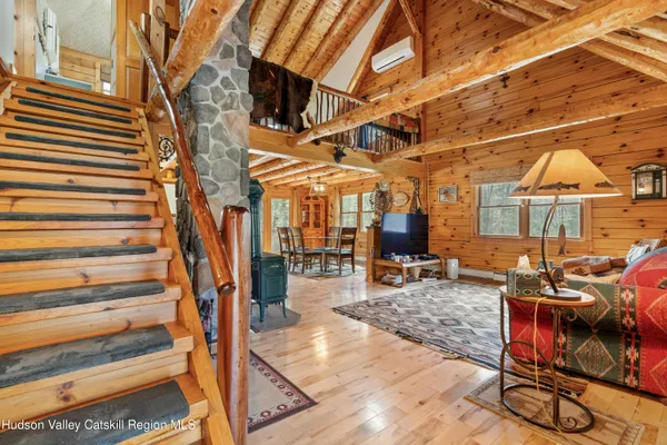 a dining hall with stainless steel appliances refrigerator a dining table and chairs with the view of kitchen