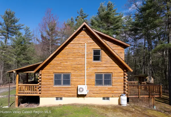 a view of house with backyard space and seating