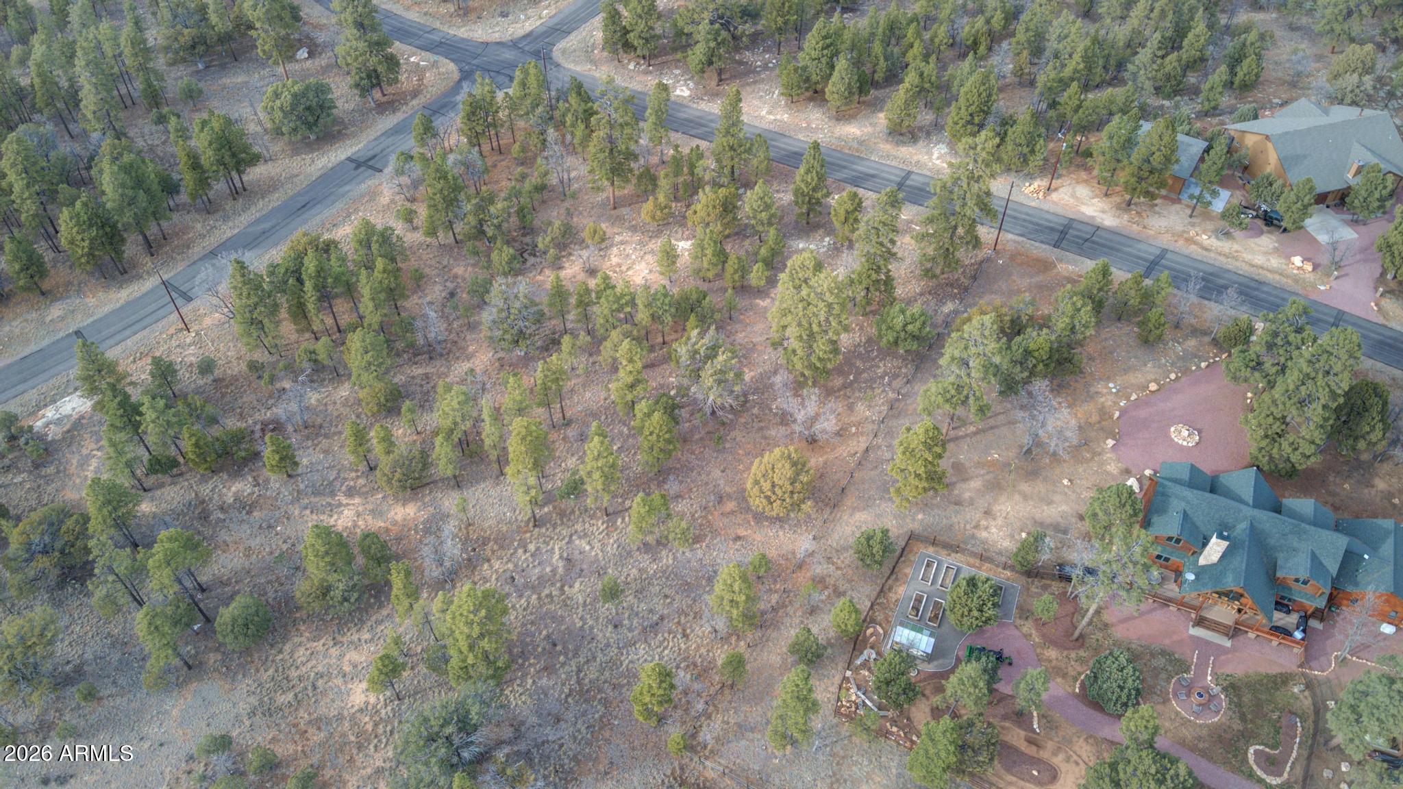 5527 Datil Circle, Unit 325 Happy Jack, AZ 86024 - Photo 16 of 21 a backyard of a house with a yard and outdoor seating