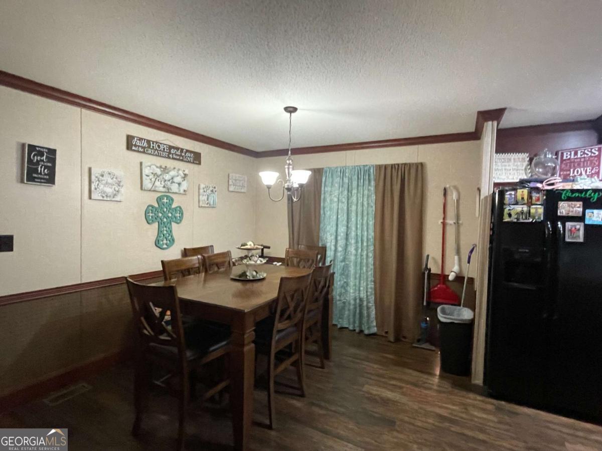 601 Auburn Road Glennville, GA 30427 - Photo 11 of 17 a view of a dining room with furniture and chandelier