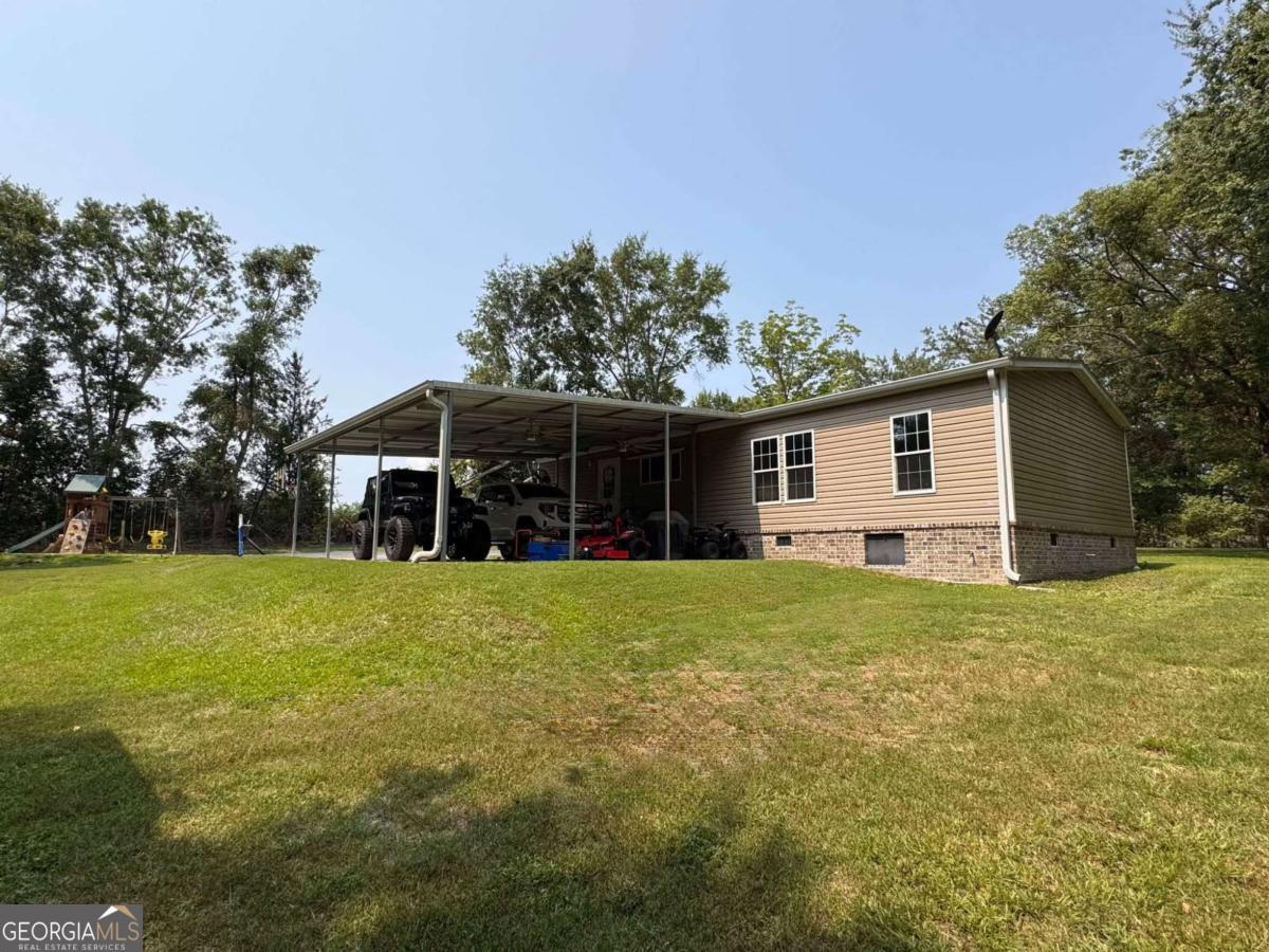 601 Auburn Road Glennville, GA 30427 - Photo 2 of 17 a front view of house with yard and green space