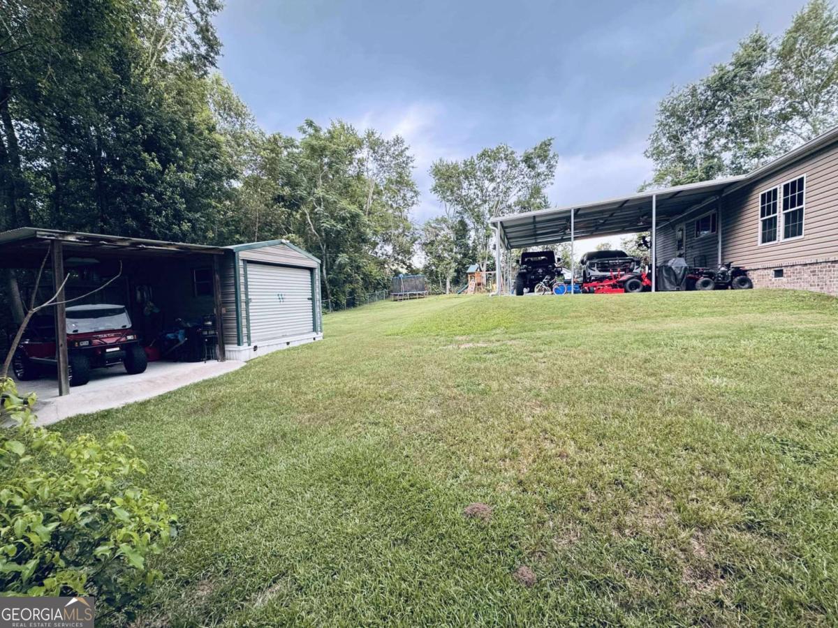 601 Auburn Road Glennville, GA 30427 - Photo 4 of 17 a front view of a house with garden