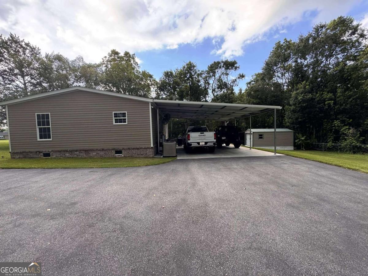 601 Auburn Road Glennville, GA 30427 - Photo 5 of 17 a view of a house with backyard and trees