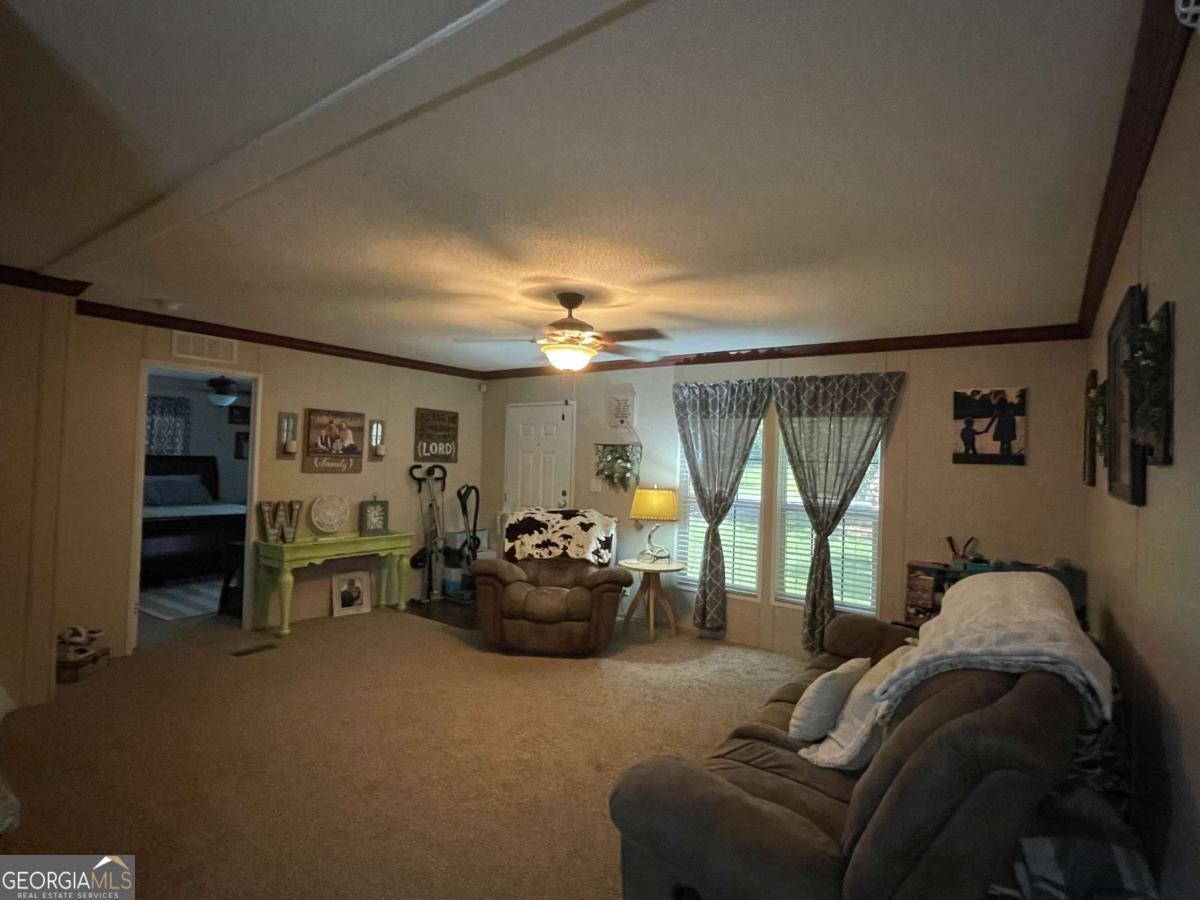 601 Auburn Road Glennville, GA 30427 - Photo 8 of 17 a living room with furniture and a chandelier