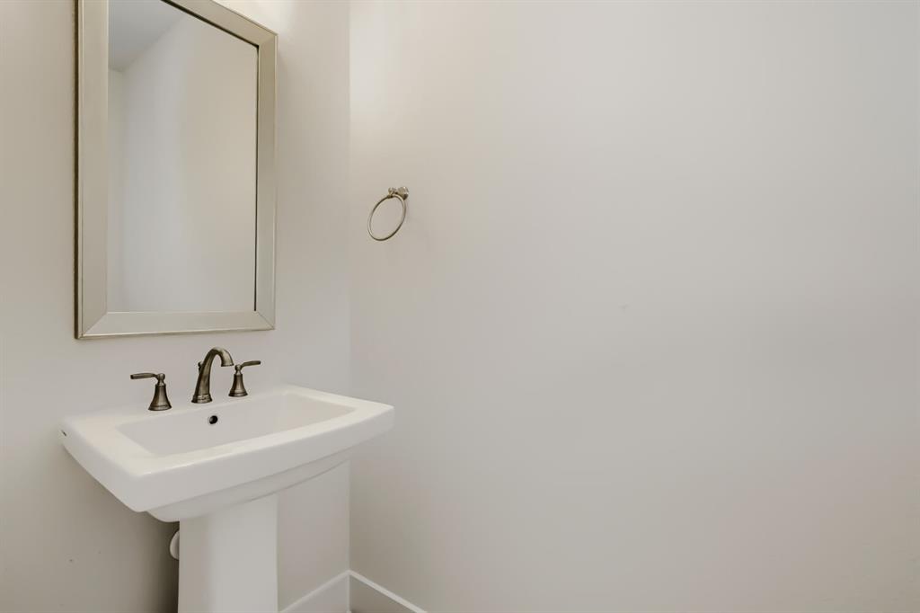 828 Stone Grv Road Lavon, TX 75166 - Photo 9 of 27 Pedestal sink with a wide basin, bronze-finish faucet, and coordinating towel ring