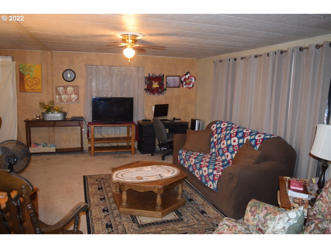 2414 North Ott Road Hermiston, OR 97838 - Photo 2 of 23 a living room with furniture and a flat screen tv