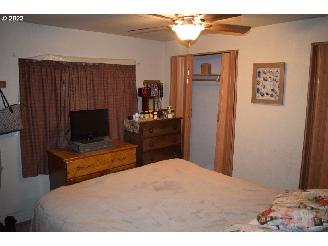2414 North Ott Road Hermiston, OR 97838 - Photo 8 of 23 a bedroom with a bed and a television