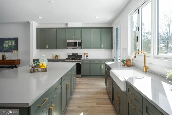 a view of a dining room with furniture a rug and wooden floor