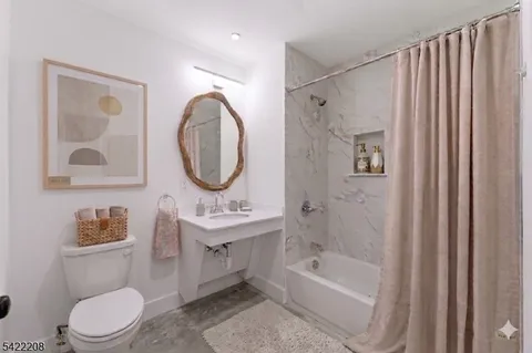 a bathroom with a toilet a sink and a bathtub
