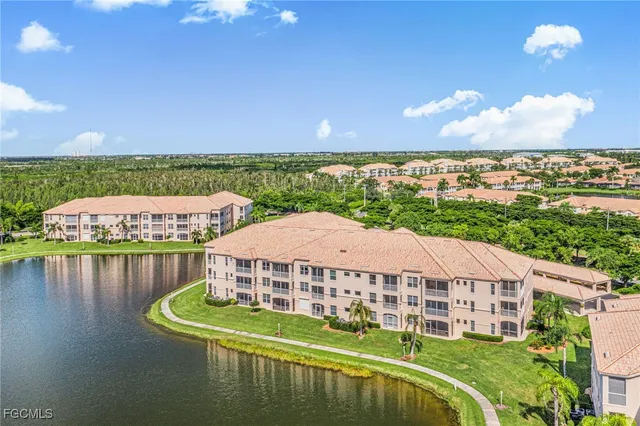 a view of a big house with pool and lawn chairs