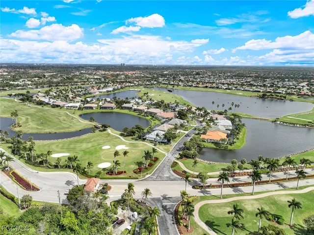 an aerial view of a houses with a yard