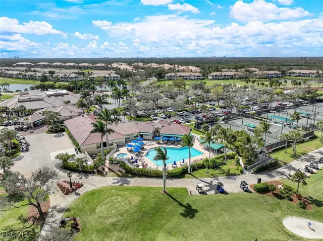 an aerial view of residential houses with outdoor space and lake view