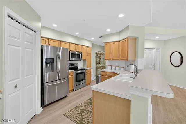 a kitchen with refrigerator cabinets and a sink