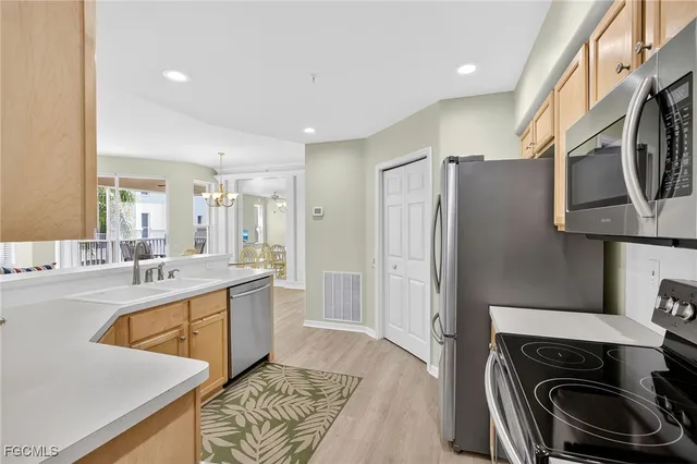 a kitchen with a sink stove and refrigerator