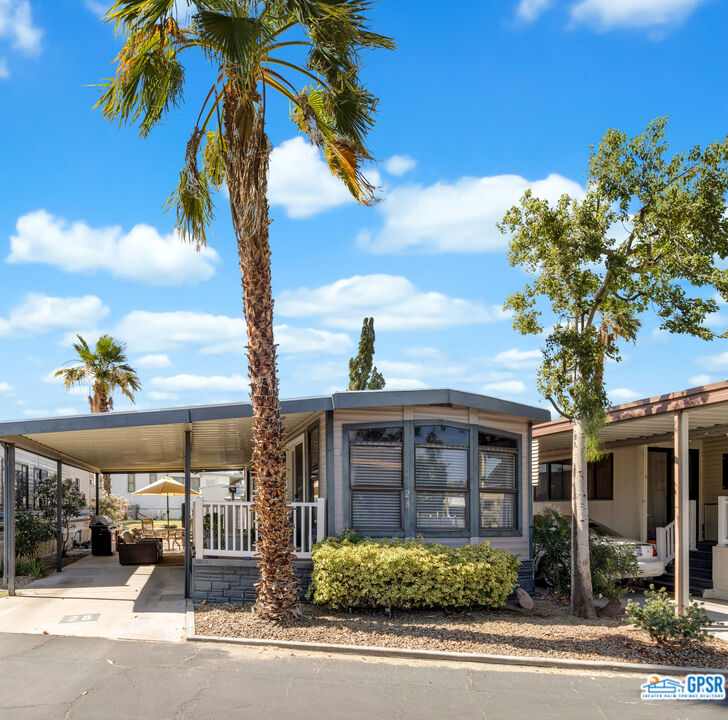 69801 Ramon Road, Unit 28 Cathedral City, CA 92234 - Photo 1 of 20 a front view of a house with a yard