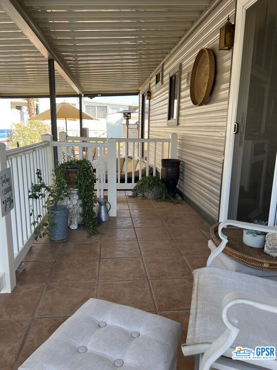 69801 Ramon Road, Unit 28 Cathedral City, CA 92234 - Photo 3 of 20 a view of a porch with furniture