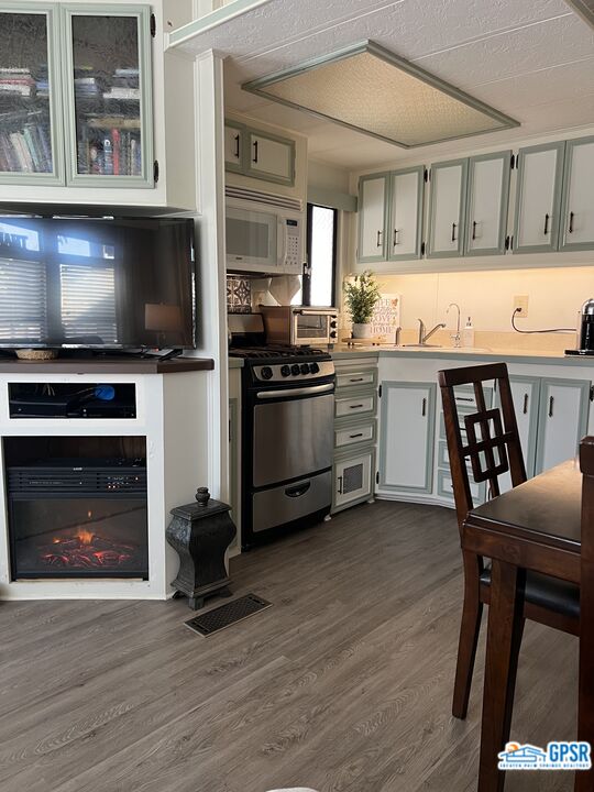 69801 Ramon Road, Unit 28 Cathedral City, CA 92234 - Photo 10 of 20 a kitchen with stainless steel appliances a stove a sink and a microwave