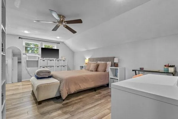 a bedroom with a bed and a ceiling fan