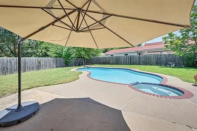 a view of a backyard with a swimming pool