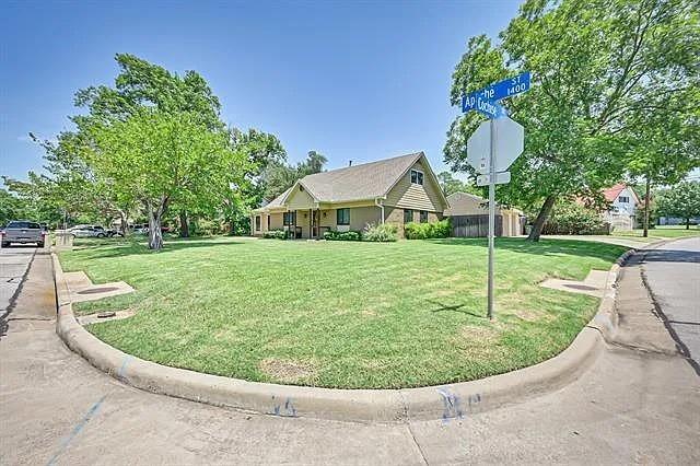 1401 Apache Street Arlington, TX 76012 - Photo 2 of 17 a view of a house with a backyard porch and sitting area