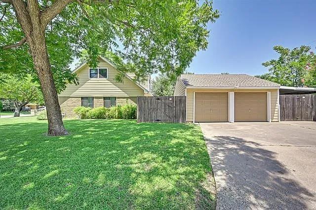 1401 Apache Street Arlington, TX 76012 - Photo 3 of 17 a front view of a house with a yard