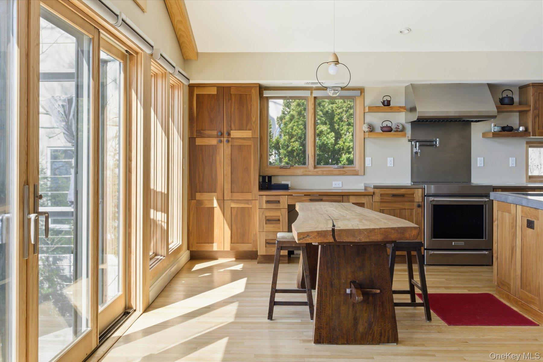 154 Eatons Neck Road Northport, NY 11768 - Photo 13 of 39 a dining hall with stainless steel appliances granite countertop a stove and a refrigerator