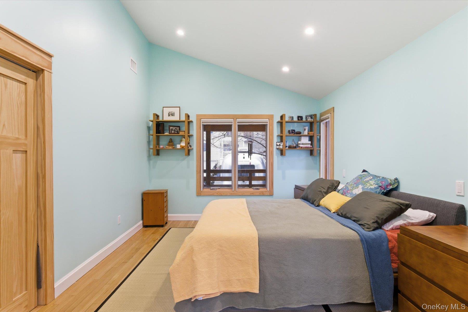 154 Eatons Neck Road Northport, NY 11768 - Photo 15 of 39 a bed room with a bed and a large window