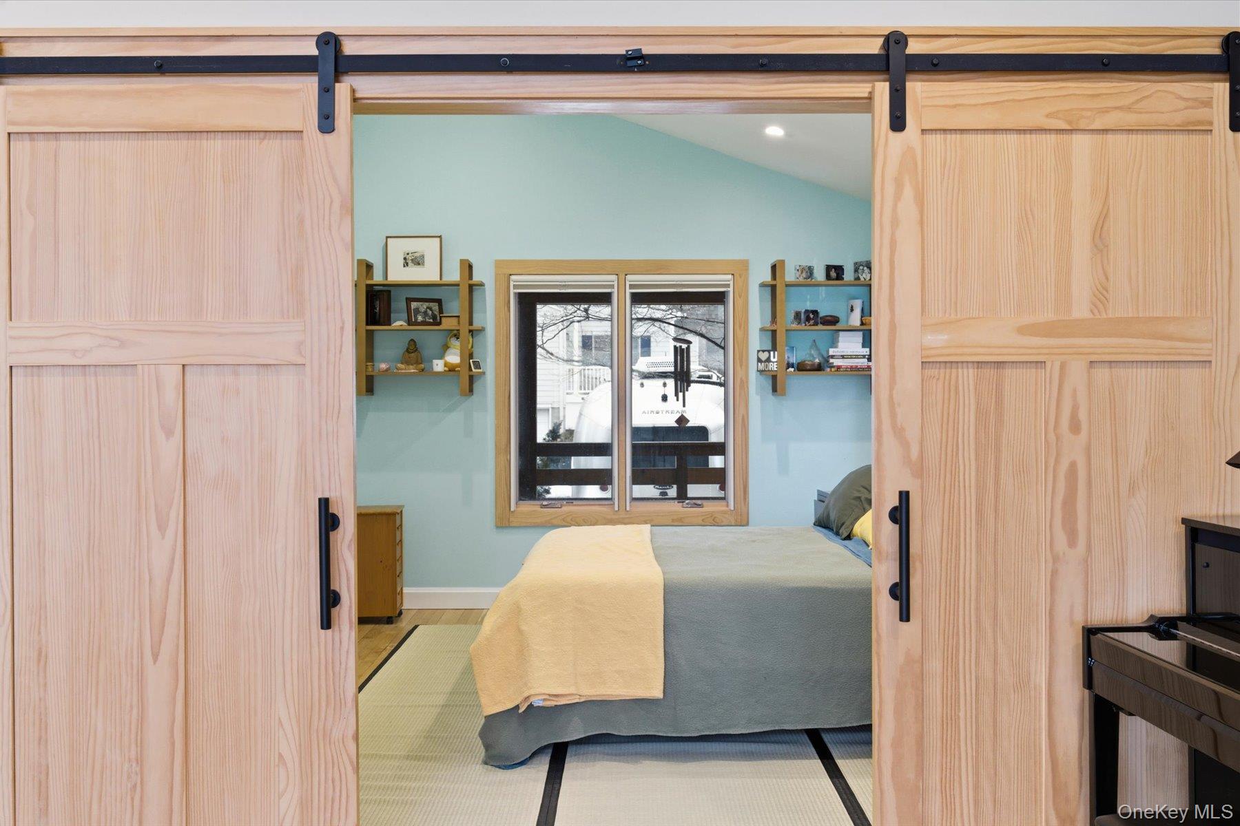 154 Eatons Neck Road Northport, NY 11768 - Photo 16 of 39 a bedroom with a bed and a window