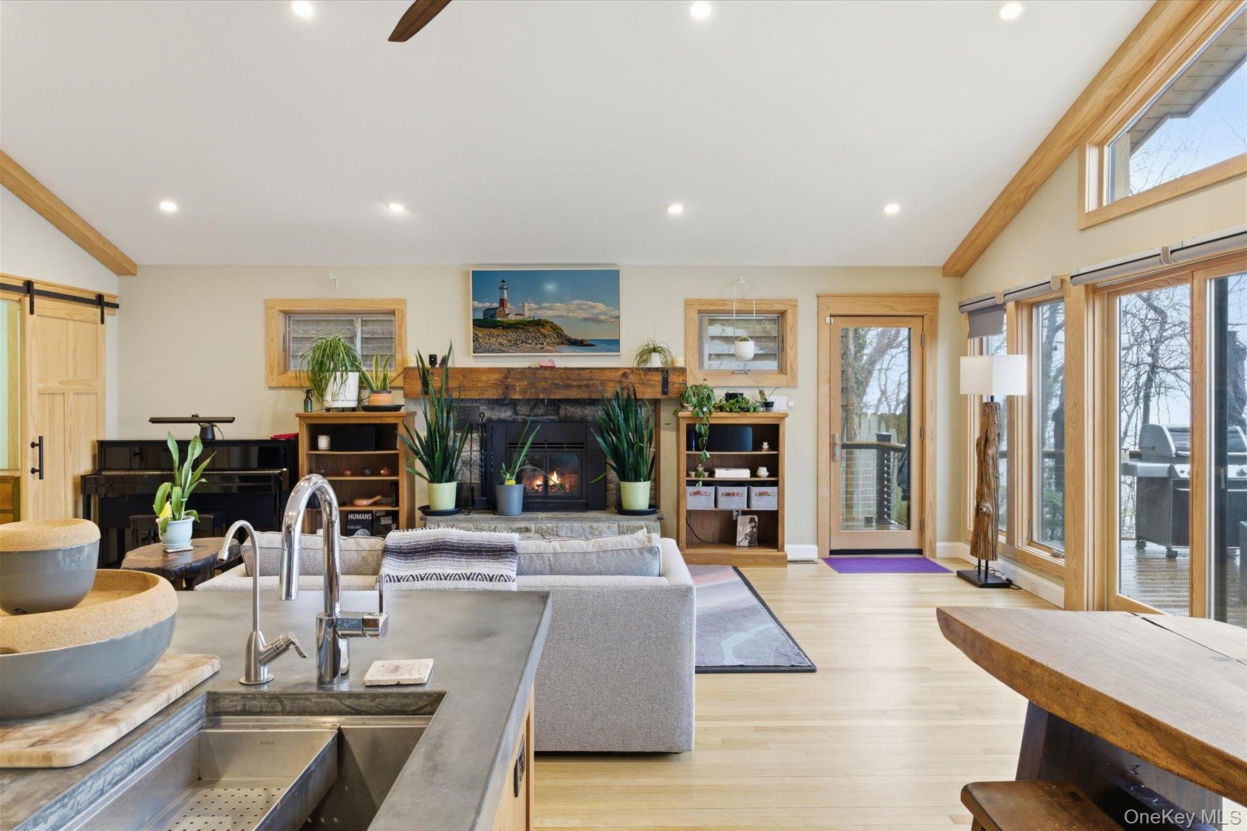 154 Eatons Neck Road Northport, NY 11768 - Photo 18 of 39 a living room with furniture a fireplace and a flat screen tv
