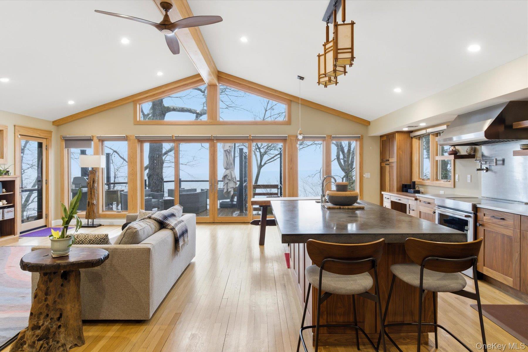 154 Eatons Neck Road Northport, NY 11768 - Photo 20 of 39 a dining room with furniture a chandelier and wooden floor