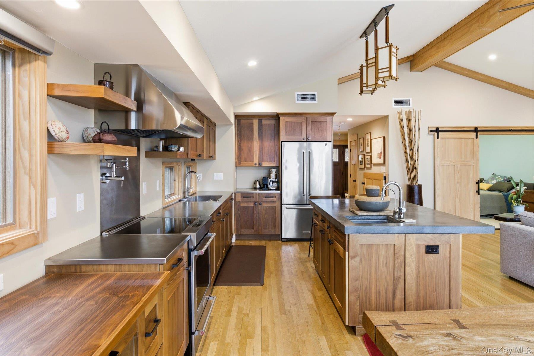 154 Eatons Neck Road Northport, NY 11768 - Photo 25 of 39 a kitchen with stainless steel appliances granite countertop a refrigerator a sink dishwasher a stove and a dining table with wooden floor