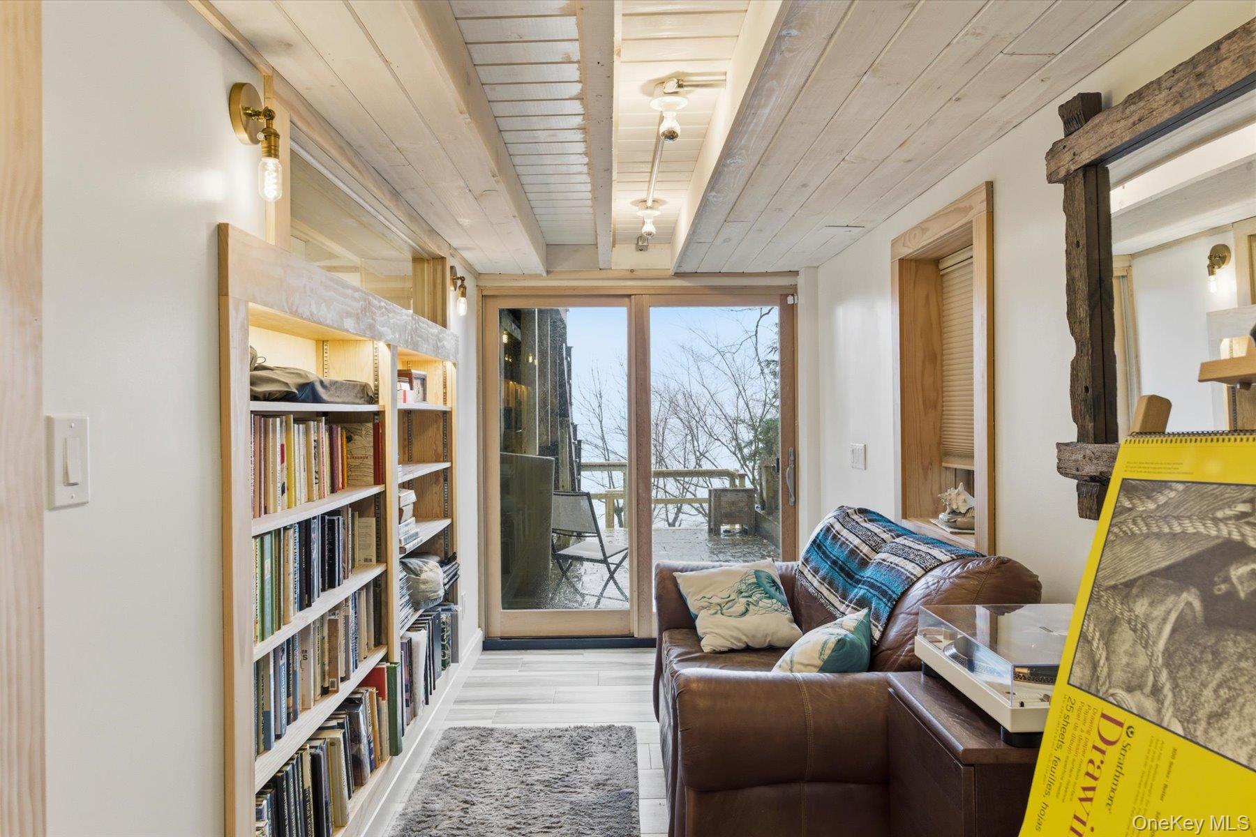 154 Eatons Neck Road Northport, NY 11768 - Photo 28 of 39 a living room with furniture and a floor to ceiling window