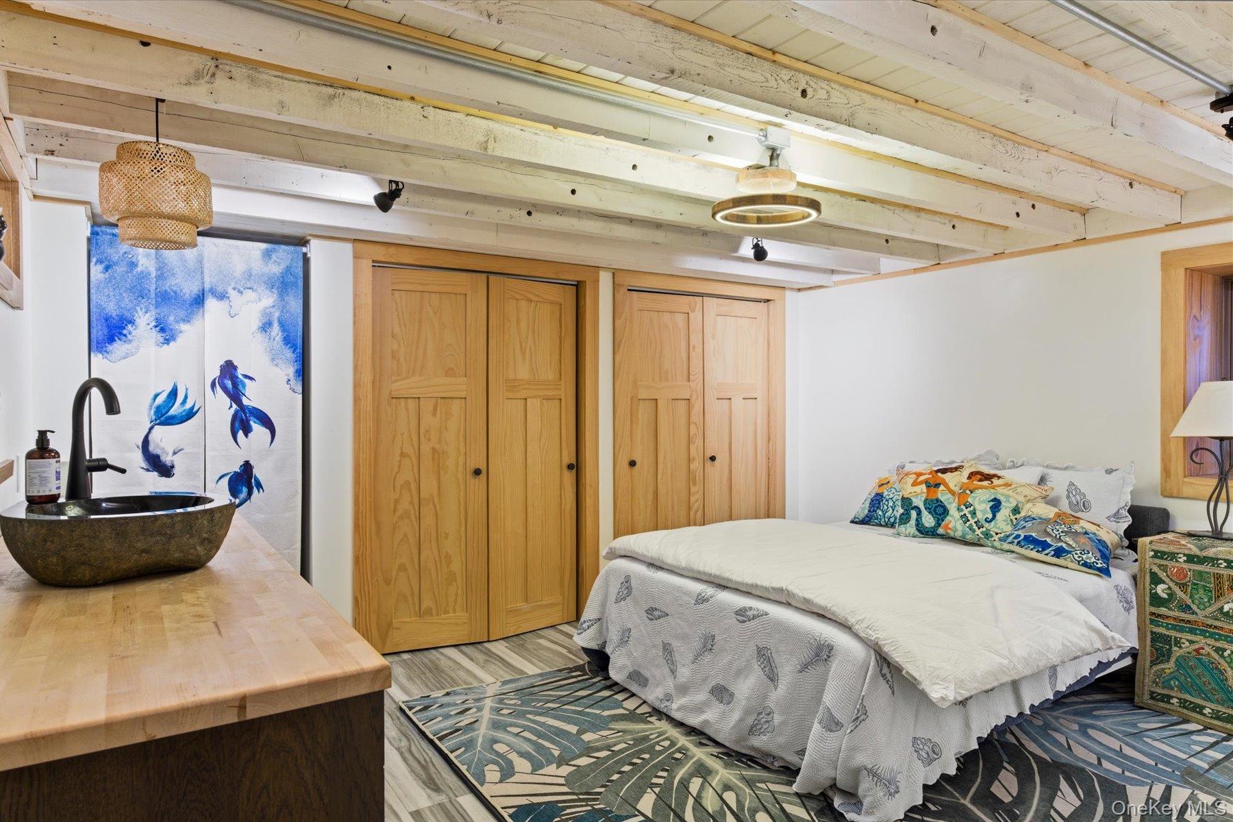 154 Eatons Neck Road Northport, NY 11768 - Photo 29 of 39 a bedroom with a bed and a window