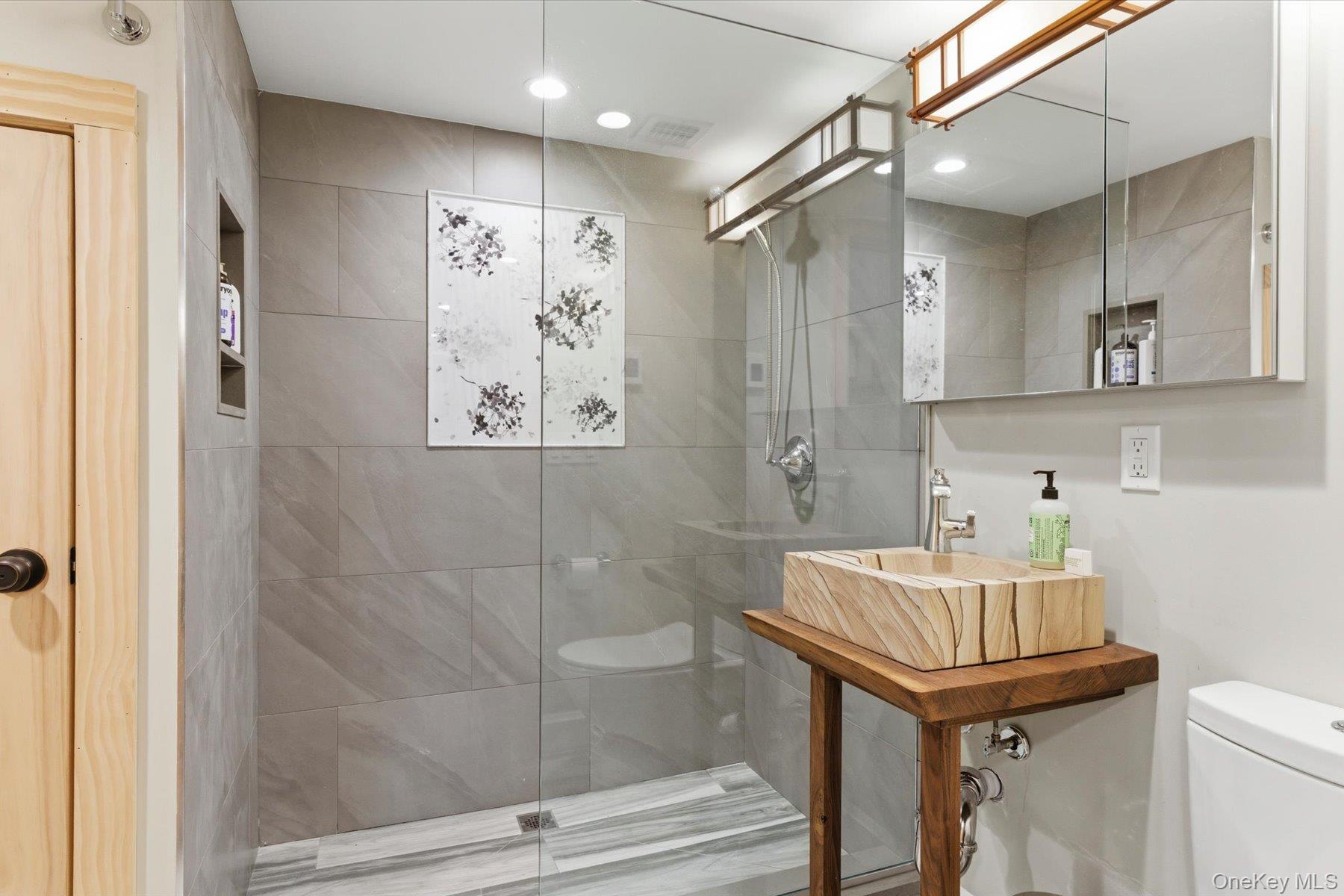 154 Eatons Neck Road Northport, NY 11768 - Photo 30 of 39 a bathroom with a sink a toilet and shower