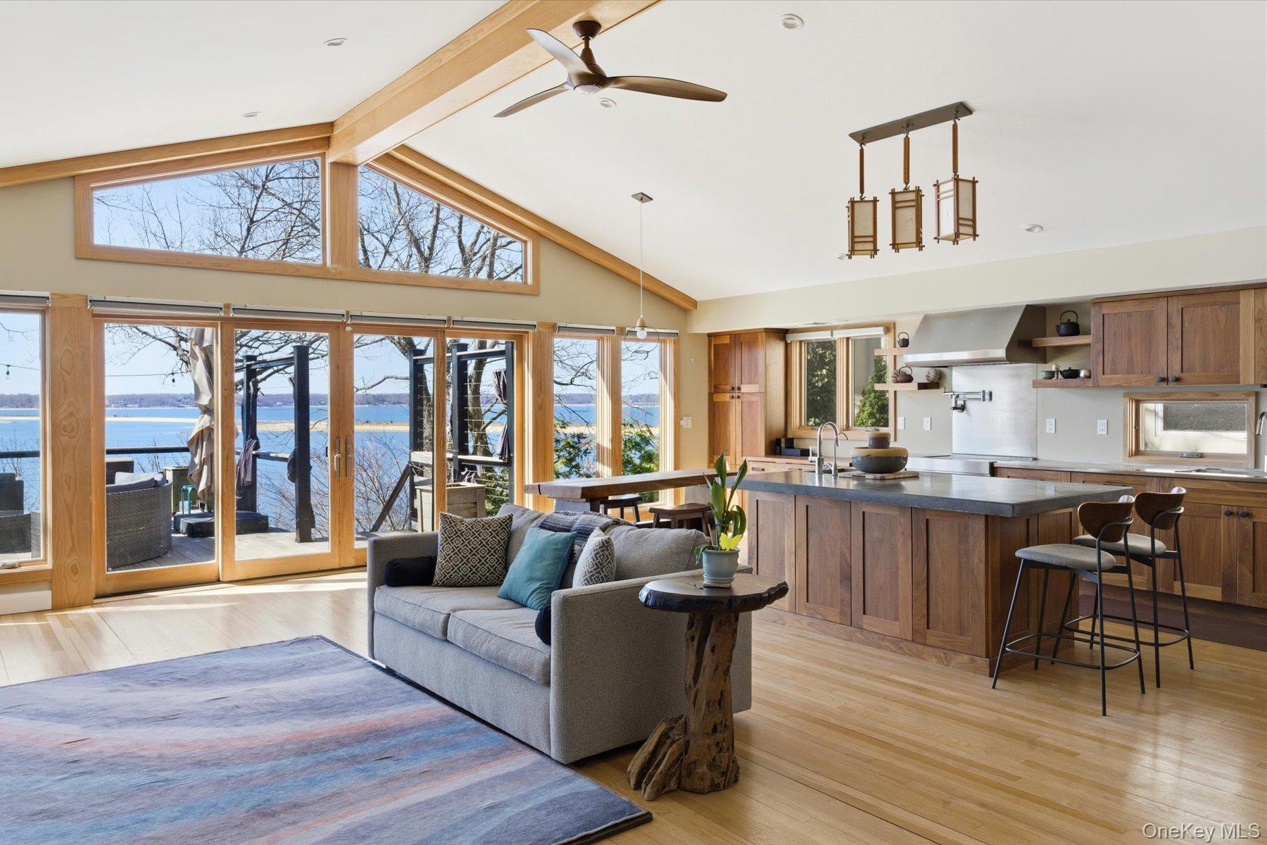 154 Eatons Neck Road Northport, NY 11768 - Photo 5 of 39 a living room with stainless steel appliances granite countertop furniture a couch and a large window