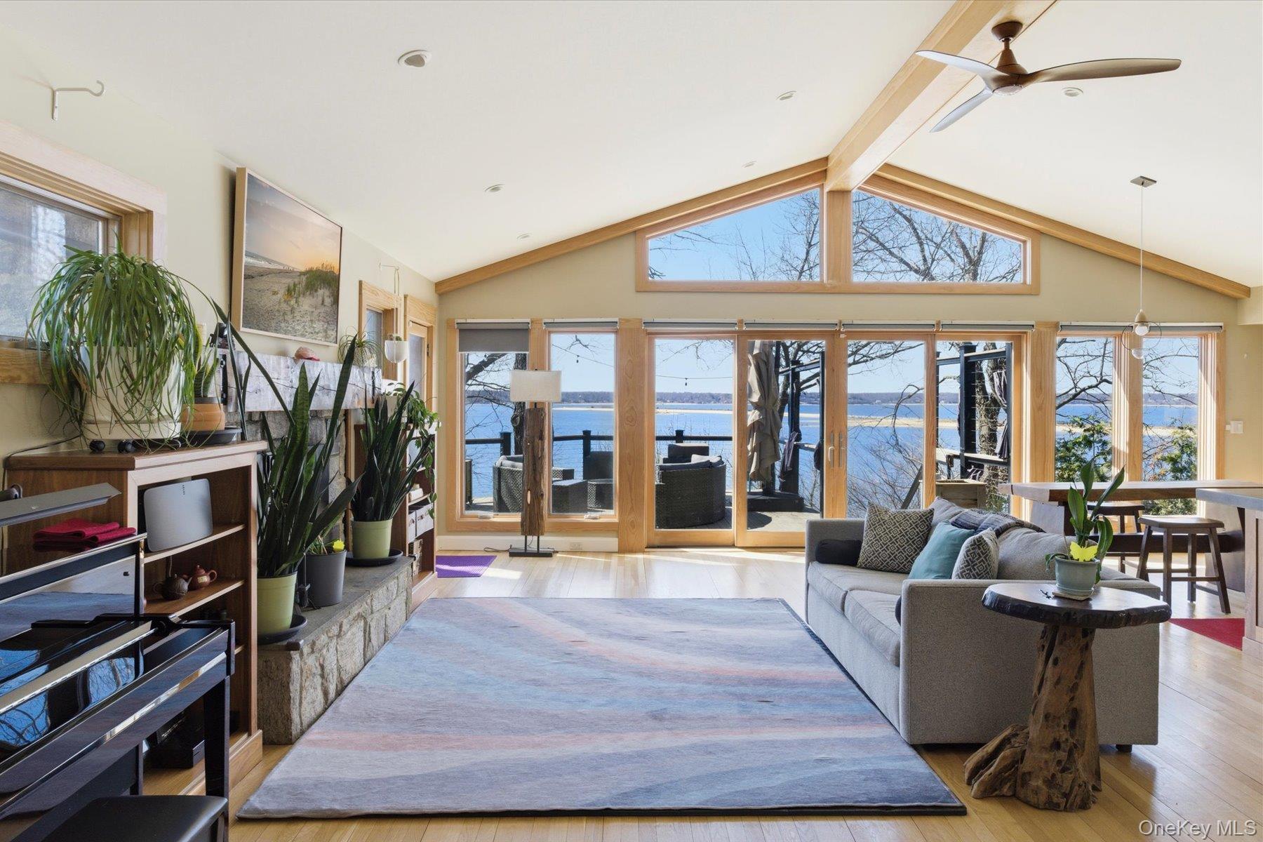 154 Eatons Neck Road Northport, NY 11768 - Photo 6 of 39 a living room with furniture and a floor to ceiling window