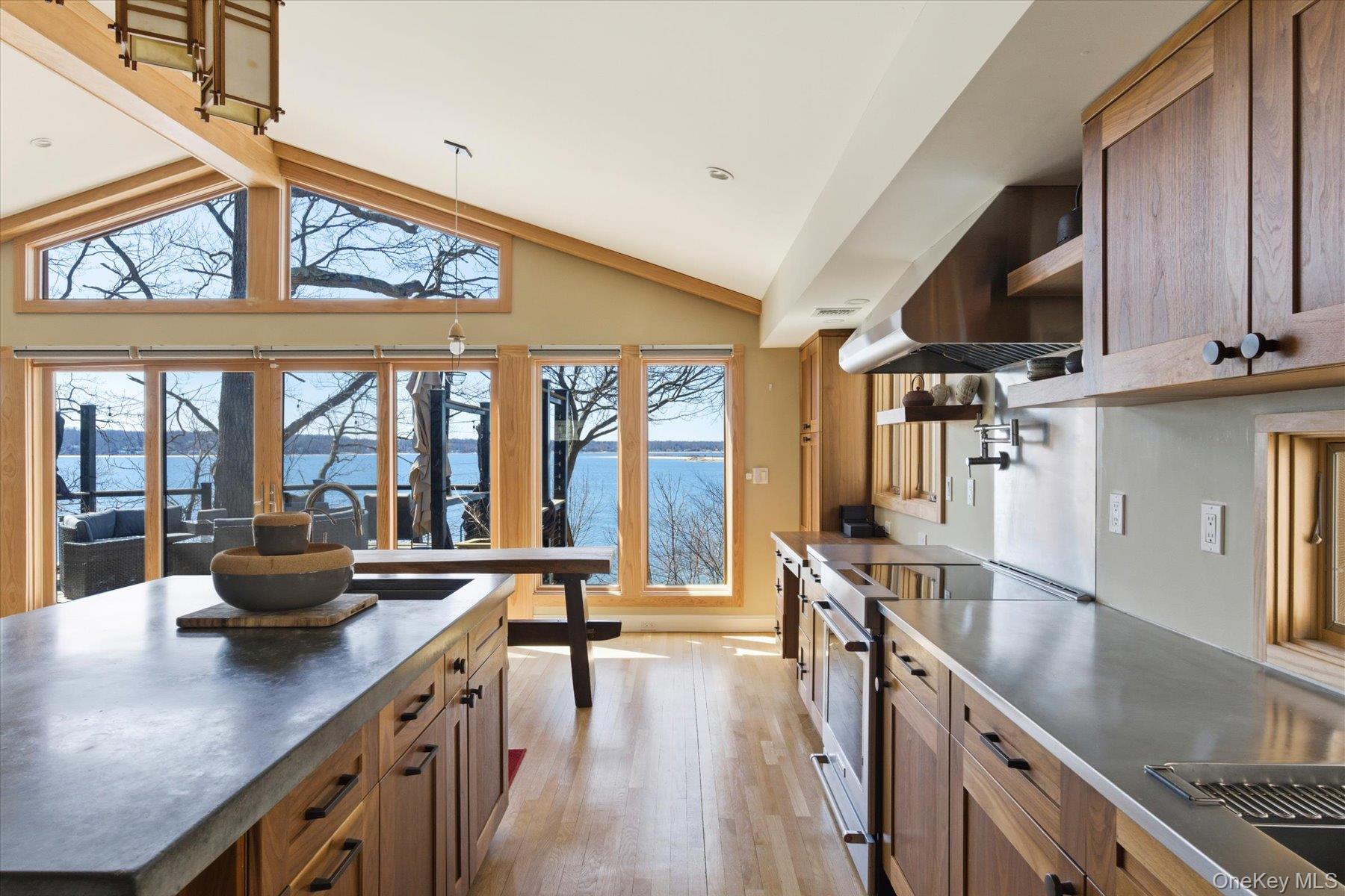 154 Eatons Neck Road Northport, NY 11768 - Photo 7 of 39 a kitchen with stainless steel appliances kitchen island granite countertop a large window a sink and counter space