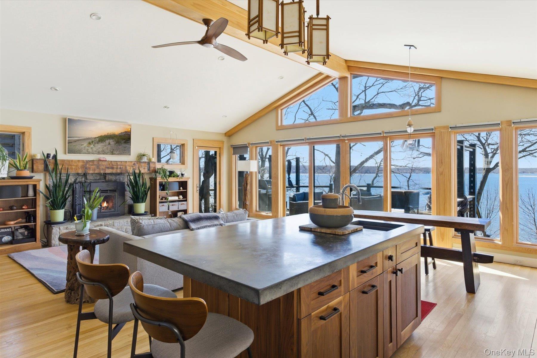 154 Eatons Neck Road Northport, NY 11768 - Photo 10 of 39 a kitchen with stainless steel appliances granite countertop a table chairs and a view of living room