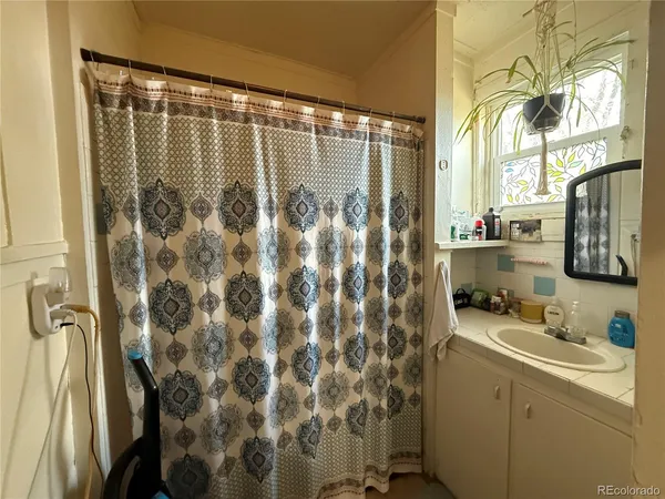 a bathroom with a sink and a shower curtain