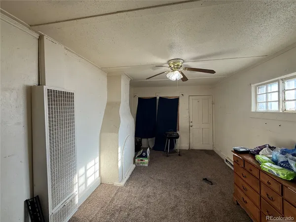 a bathroom with a toilet and shower curtain