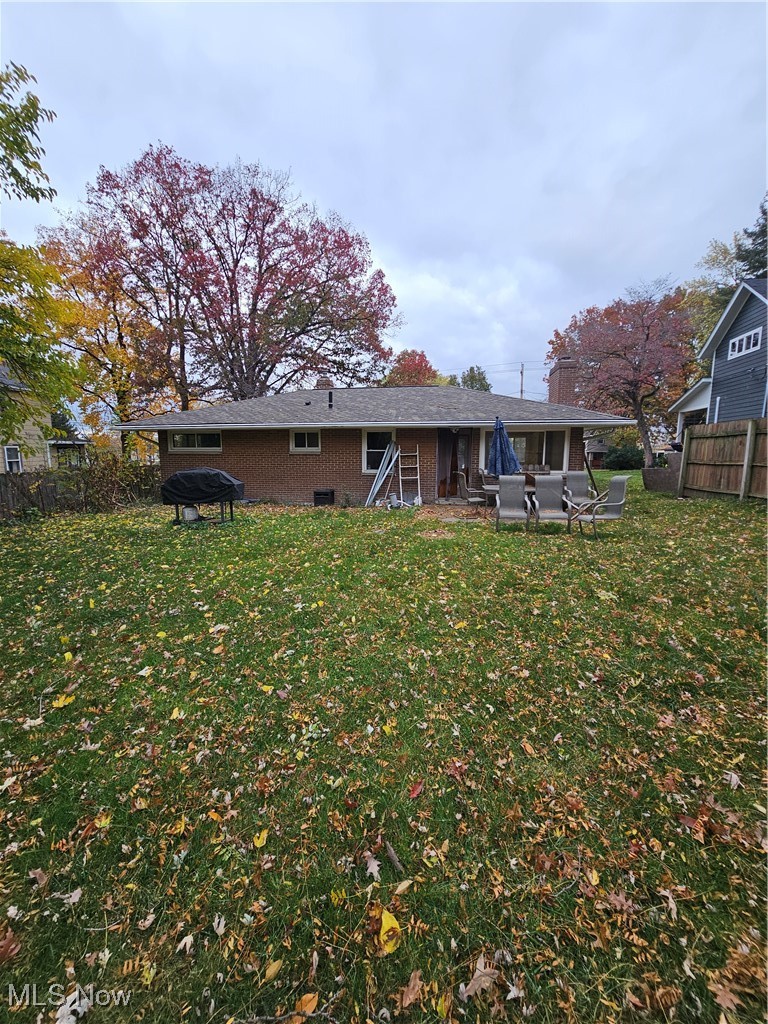 945 West Schaaf Road Cleveland, OH 44109 - Photo 18 of 27 Back of property with a patio, a lawn, and a fire pit