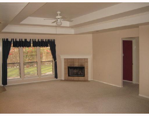 5210 Lethaby Drive Corpus Christi, TX 78413 - Photo 2 of 5 an empty room with a fireplace and windows