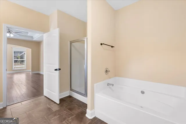a bathroom with a bathtub and shower