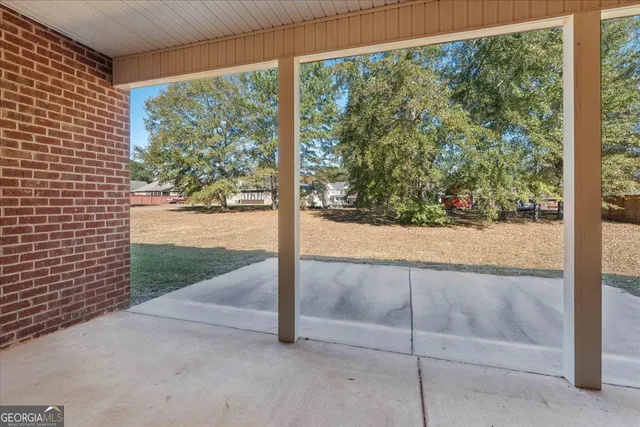 a view of a room with wooden floor and fence